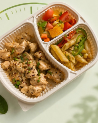 Chicken, penne and fresh salad in a three-part tray